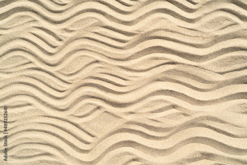 Texture of sea sand background closeup with ornament Texture of sea sand background closeup with ornament