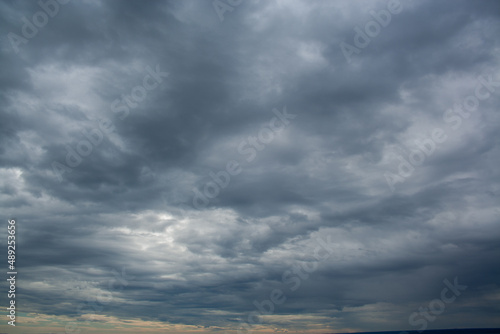 Cloudscape before rain background. Clouds pattern. Heavy hanging clouds high in the sky.