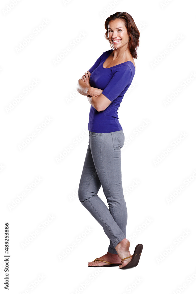 Standing with style. Full length side view of an attractive woman standing with her arms folded and smiling widely. Standing with style. Full length side view of an attractive woman standing with her arms folded and smiling widely.
