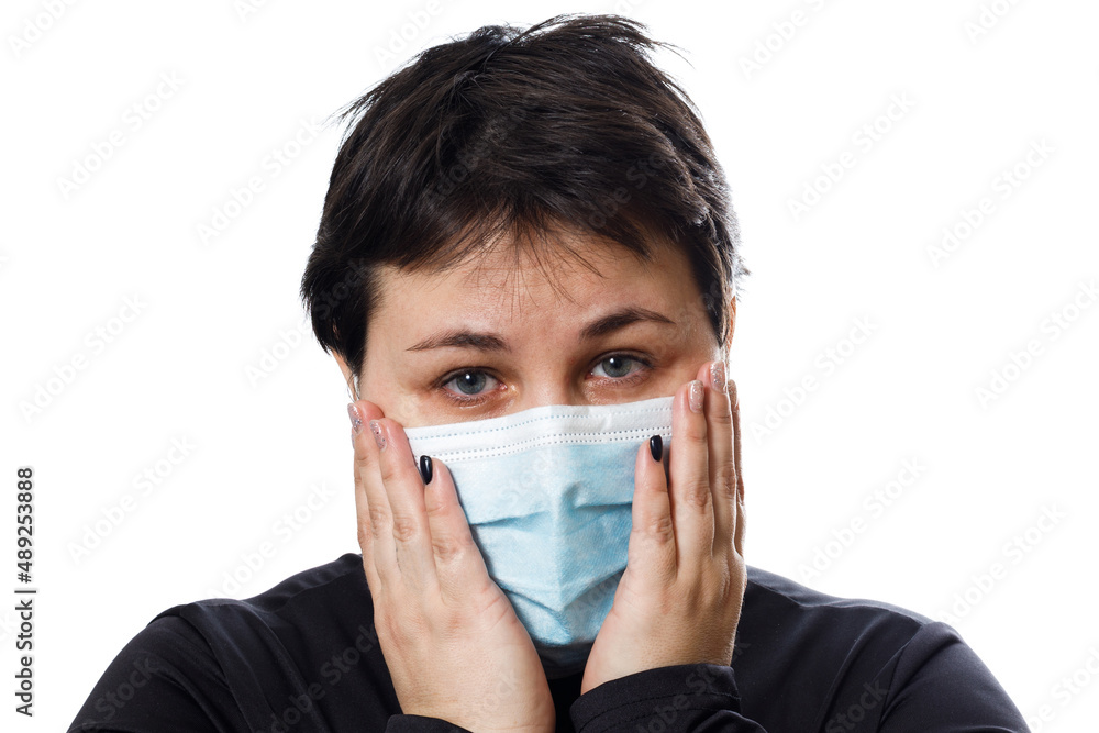 brunette woman with sad eyes in medical mask isolated on white background brunette woman with sad eyes in medical mask isolated on white background