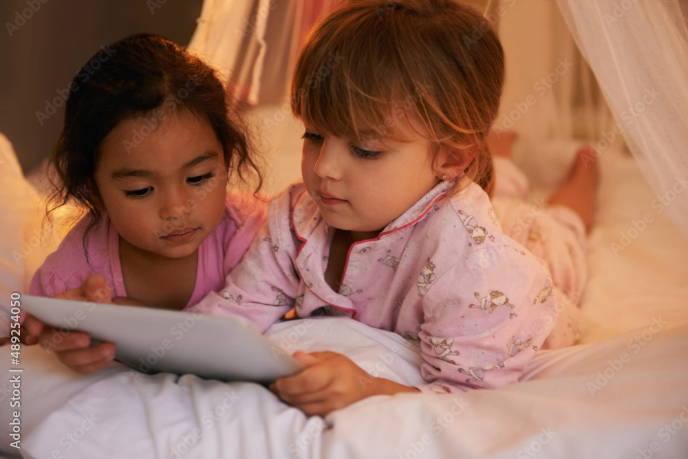 I LOVE sleepovers. Shot of two cute little girls reading a story together. I LOVE sleepovers. Shot of two cute little girls reading a story together.