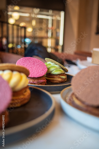 Colourful danish fastelavnsbolle with jam, whipped cream and almond paste in laminated pastry dough with powdered sugar on top served in Copenhagen, Denmark in a cafe bakery Andersen Bakery