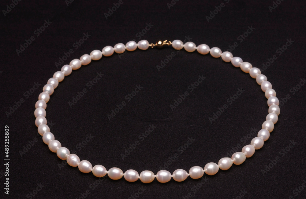 Pearl necklace on matte black background. Pearl necklace on matte black background.