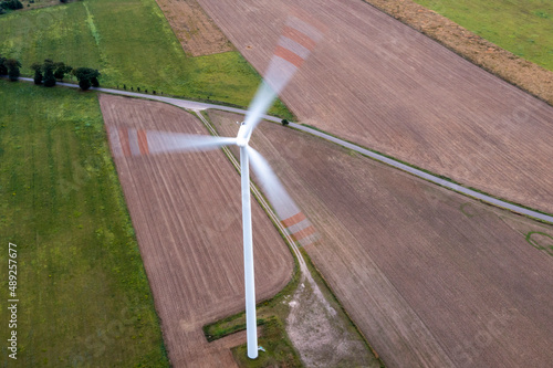 Going green with a wind power from a modern eco windmill turbine. © _maciej_