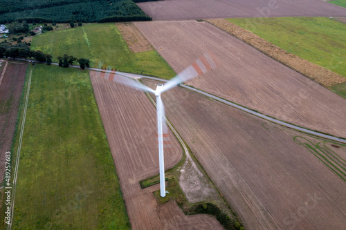 Going green with a wind power from a modern eco windmill turbine. © _maciej_