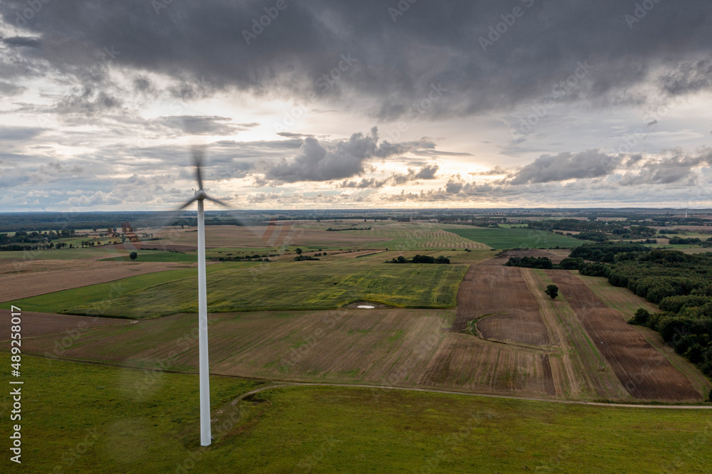 Going green with a wind power from a modern eco windmill turbine. Going green with a wind power from a modern eco windmill turbine.