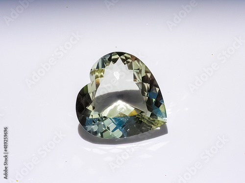 heart shaped faceted green gemstone   on white background