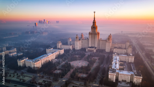 Aerial view of Moscow State University on a foggy day. Amazing sun rise. Moscow City trade and business center is covered with fog