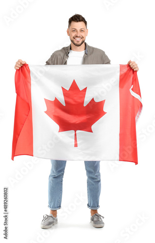 Happy young man with flag o...
