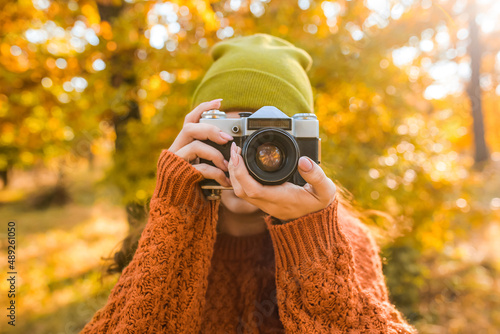 Woman taking picture in aut...
