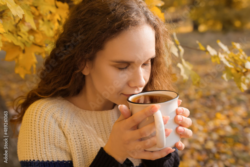 Young woman drinking tea in...