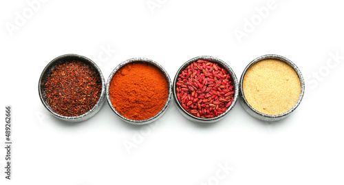 Bowls with aromatic spices on white background