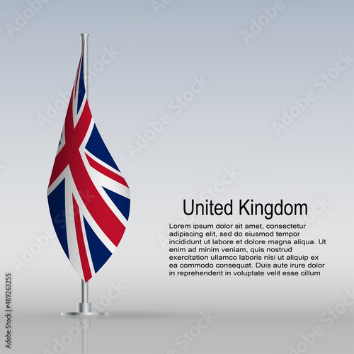 Flag of United Kingdom hanging on a flagpole stands on the table