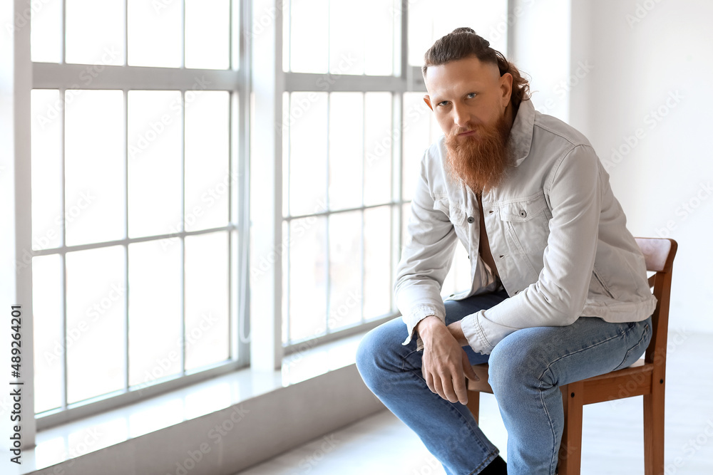 Portrait of handsome bearded man sitting on chair at home Portrait of handsome bearded man sitting on chair at home