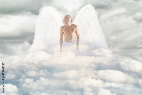 The majesty of an arch-Angel. Shot of a masculine angel walking through the heavens.