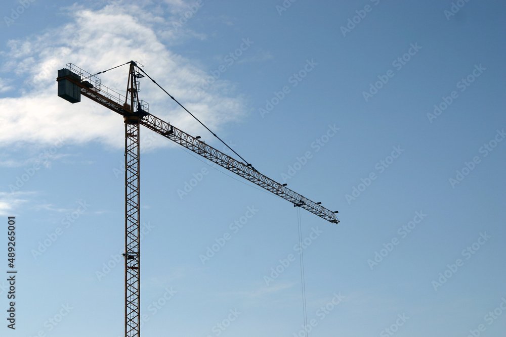 High steel crane at construction site blue sky High steel crane at construction site blue sky