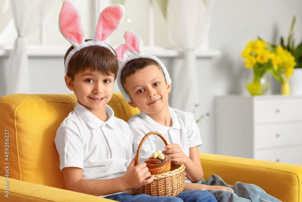 Cute little boys with bunny ears and Easter basket at home Cute little boys with bunny ears and Easter basket at home