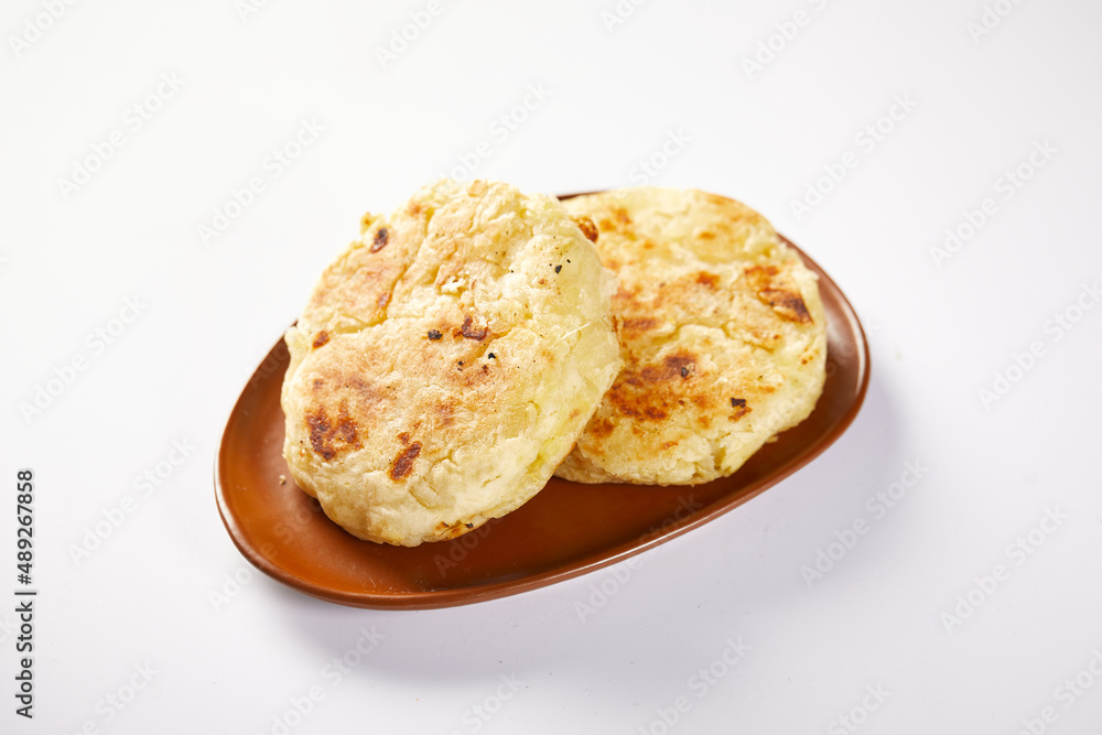 Tortilla de yuca a traditional Ecuadorian appetizer served with coffee. It’s on a white background. Tortilla de yuca a traditional Ecuadorian appetizer served with coffee. It’s on a white background.
