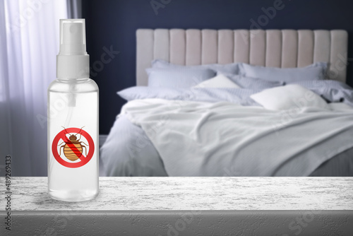 Fototapet Anti bed bug spray on stone table in bedroom. Space for text