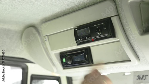 Driver removes a digital tachograph reader from the tachograph. Tachograph download. Police check. Road transport Control