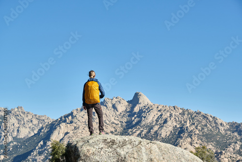 Tableau sur toile A woman hiker in the mountains, at a natural lookout point