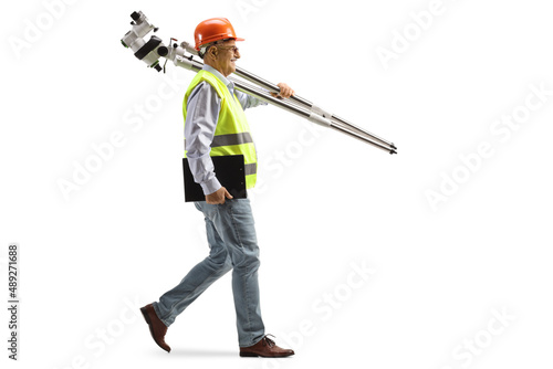Full length profile shot of an engineer walking and carrying measuring instrument © Ljupco Smokovski