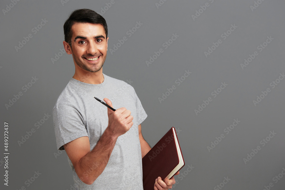 portrait man in gray t-shirts posing lifestyle casual wear Gray background portrait man in gray t-shirts posing lifestyle casual wear Gray background