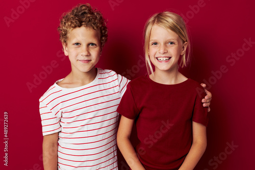 cheerful children smiling and posing in casual clothes against isolated background unaltered