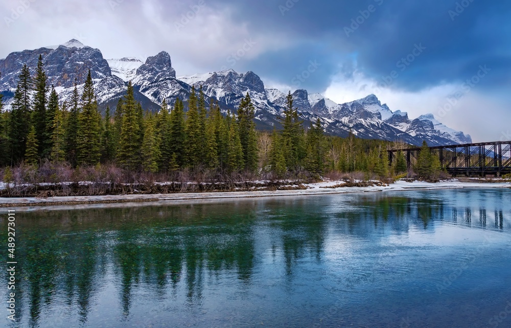 Moody Clouds Over Canmore Mountains And River