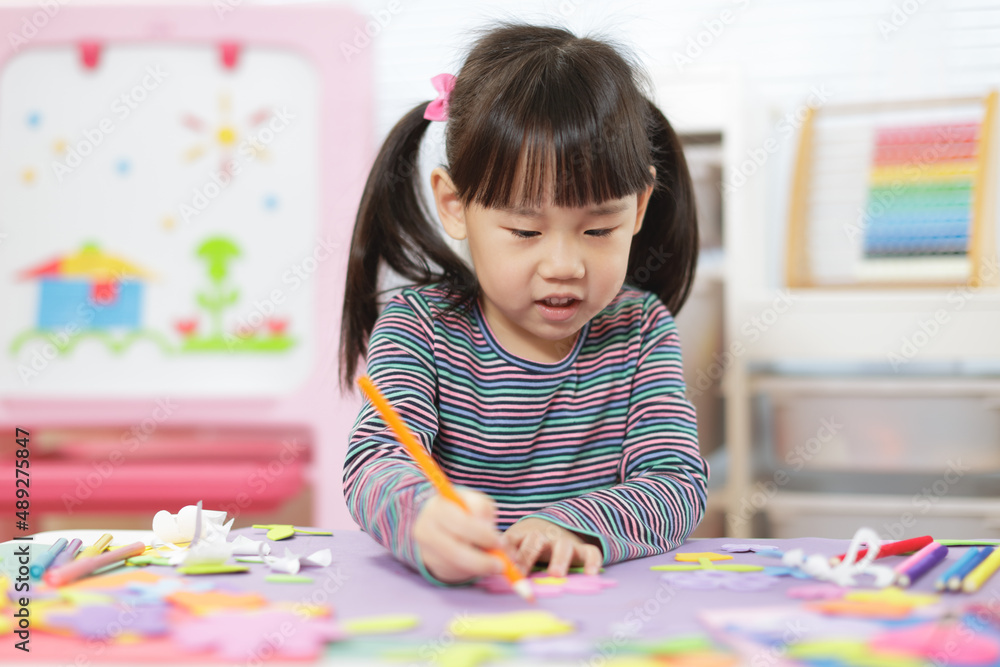young girl making craft for home schooling young girl making craft for home schooling