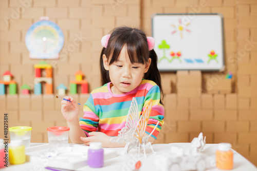 young girl hand make craft for home schooling