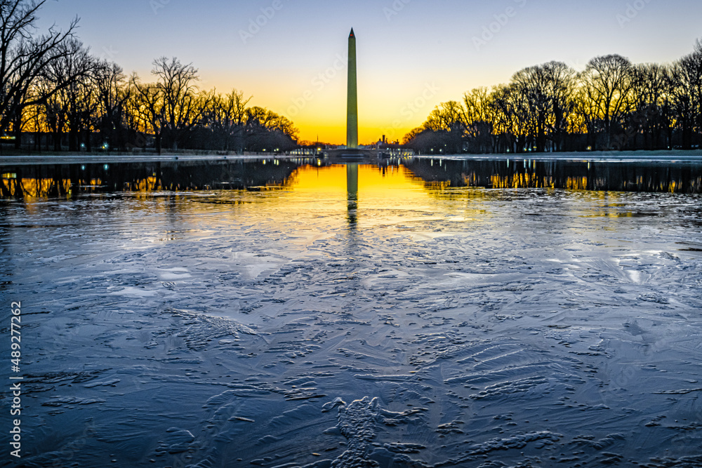 Washington Monument at sunrise with ice on the reflecting pool