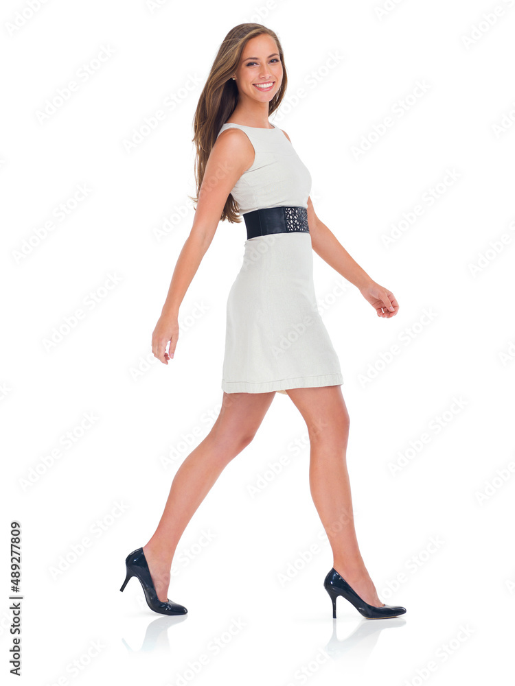 Walking with confidence. Studio shot of a stylishly-dressed young woman isolated on white. Walking with confidence. Studio shot of a stylishly-dressed young woman isolated on white.