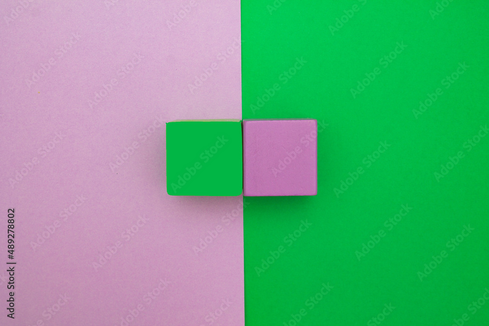 Violet and green squares on purple and green background. Color contrast. Simple composition. Violet and green squares on purple and green background. Color contrast. Simple composition.