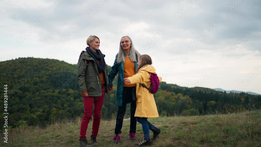 Small girl with mother and grandmother hodling hands and running outoors in nature. Small girl with mother and grandmother hodling hands and running outoors in nature.
