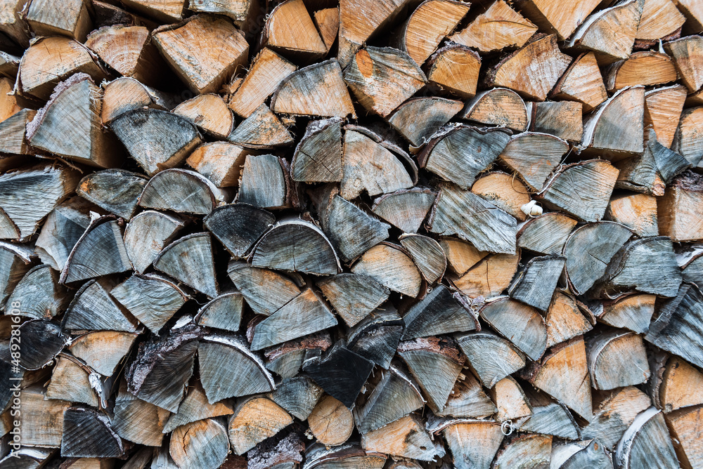 Stack of dried firewood from birch wood. Dry cut wood texture. Timber industry. Woodpile of light and grey color firewood. Wood storage place. The structure of dry birch logs. Fuel material. Stack of dried firewood from birch wood. Dry cut wood texture. Timber industry. Woodpile of light and grey color firewood. Wood storage place. The structure of dry birch logs. Fuel material.