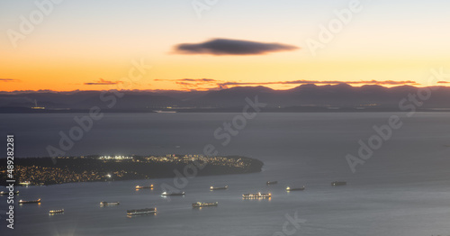 Burrard Inlet, Tanker Ships, UBC and Strait of Georgia with Island in background. Winter Sunset Twilight. View from Grouse Mountain, North Vancouver, British Columbia, Canada.