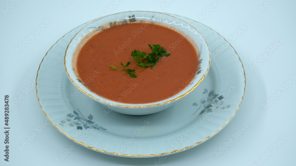 Vegetable soup with lentils in a flowery white bowl, red soup Vegetable soup with lentils in a flowery white bowl, red soup