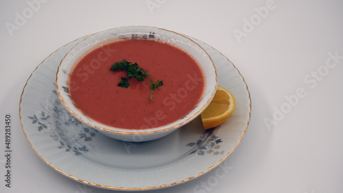 Red vegetable soup with lemon and parsley