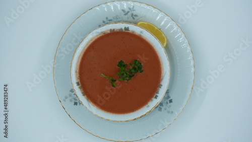 Red vegetable soup with lemon and parsley