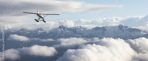 Single Engine Seaplane Flying over the Rocky Mountain Landscape. Adventure Composite. 3D Rendering Plane. Aerial Background from British Columbia near Vancouver, Canada.