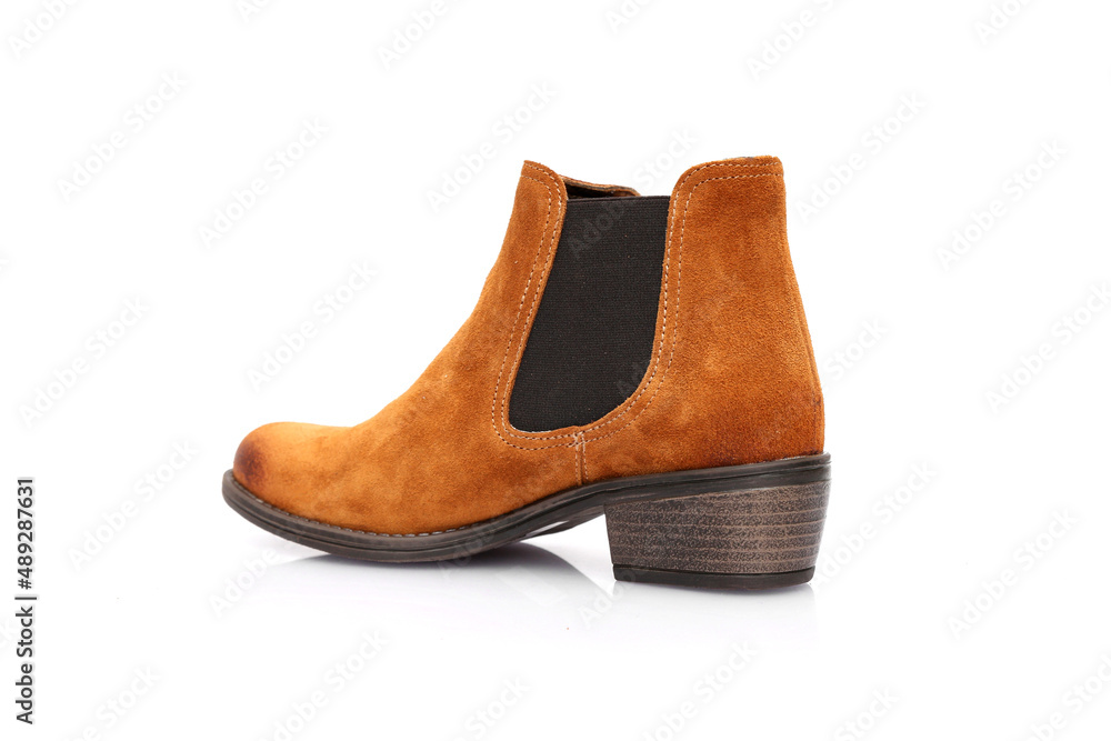 Female brown leather boots on white background, isolated product. Female brown leather boots on white background, isolated product.