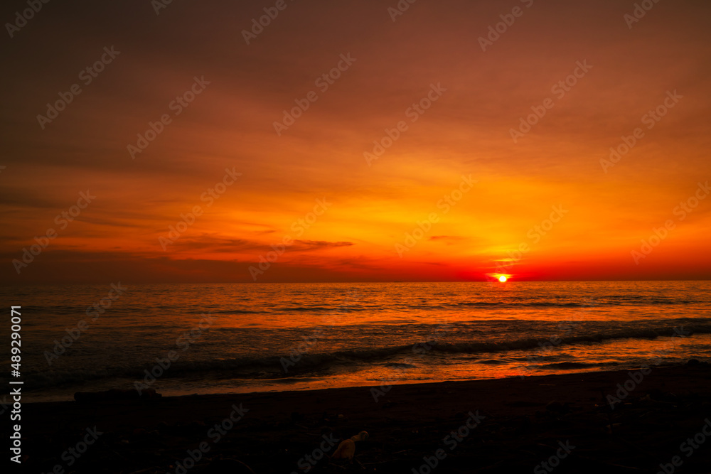 Beautiful seascape at sunset with dramatic golden sky