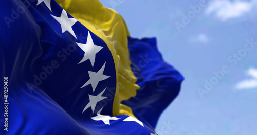Detail of the national flag of Bosnia and Herzegovina waving in the wind on a clear day. photo