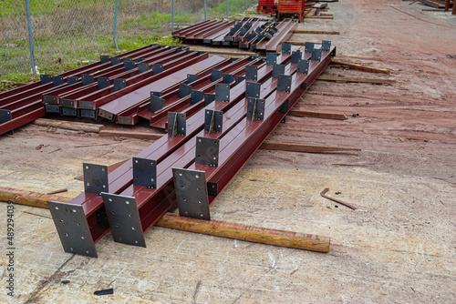Some components for a prefabricated metal building are steel columns, rafters, jambs, panels, and trim. photo