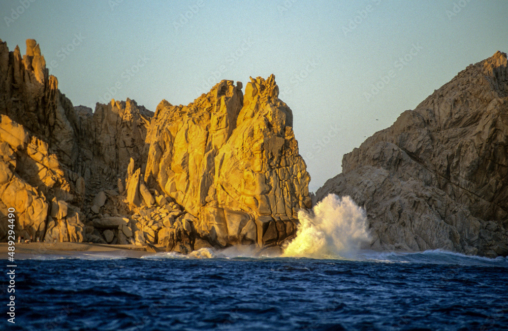 Waves crash against the rocks outside the harbor in Cabo San Lucas, Mexico