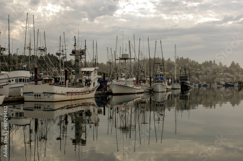 Commercial fishing vessels sit at the docks in a  port along the Oregon coast