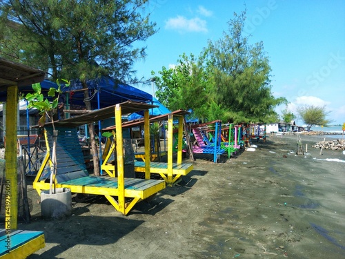 Wallpaper Mural lounge chairs for sunbathing on the beach with colorful, beach view, beach trees Torontodigital.ca