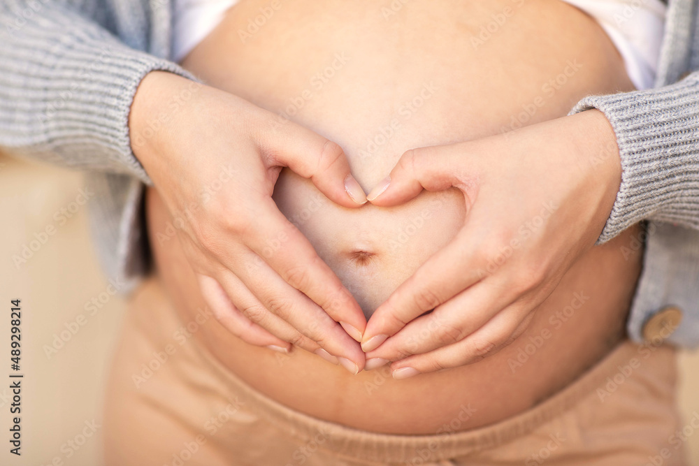 heart in the hands of a pregnant woman close-up heart in the hands of a pregnant woman close-up