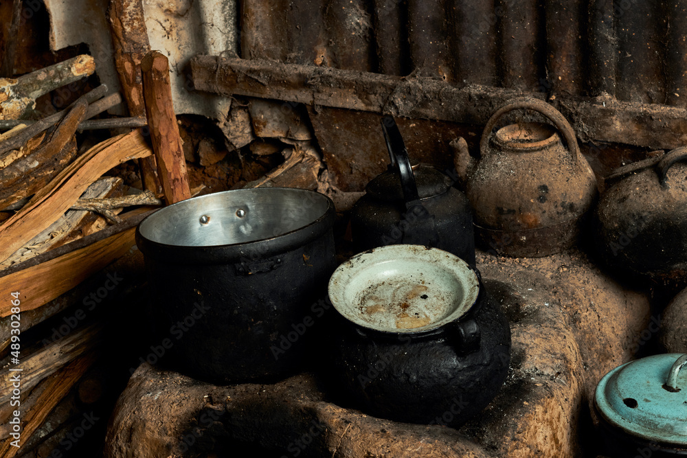 Burnt dishes on stone hearth in poor village Burnt dishes on stone hearth in poor village